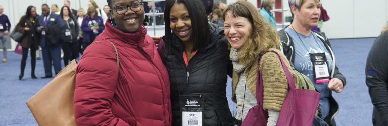 Three woman posing outside