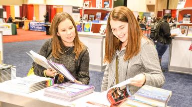 Two women looking at books