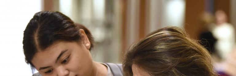 2 women reading "What Every Special Educator Should Know," the "red book" on CEC Standards