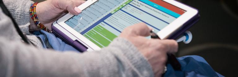 Over the shoulder of someone using a tablet