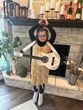 child holding a small guitar