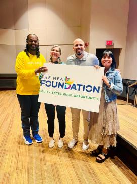 Kenyon and colleagues holding up a sign for the NEA Foundation 