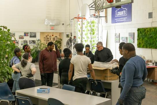 Photo of CEC's 2025 Teacher of the Year, Michael Craig, working with his students.