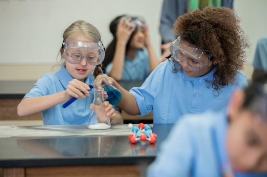 2 young female kids doing science experiment