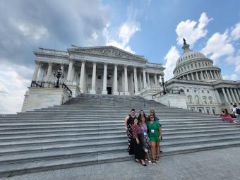 people standing on the steps of the supreme court