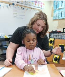 Sarah Hornback helps a student with her work.