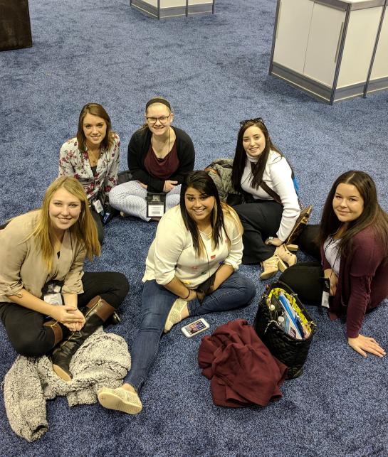 students sitting on carpet